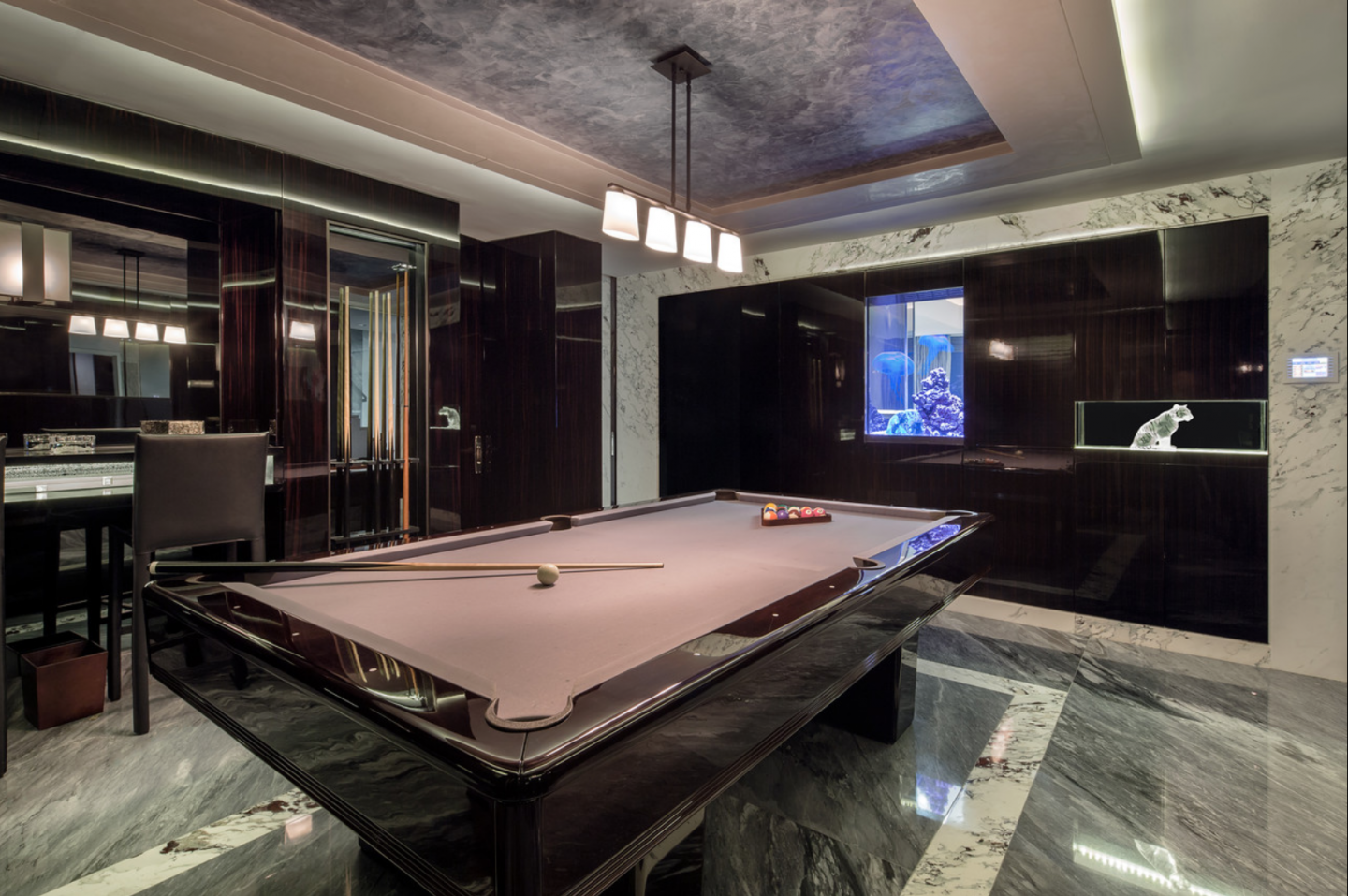 Billiards room with Calcutta built-in saltwater aquarium.