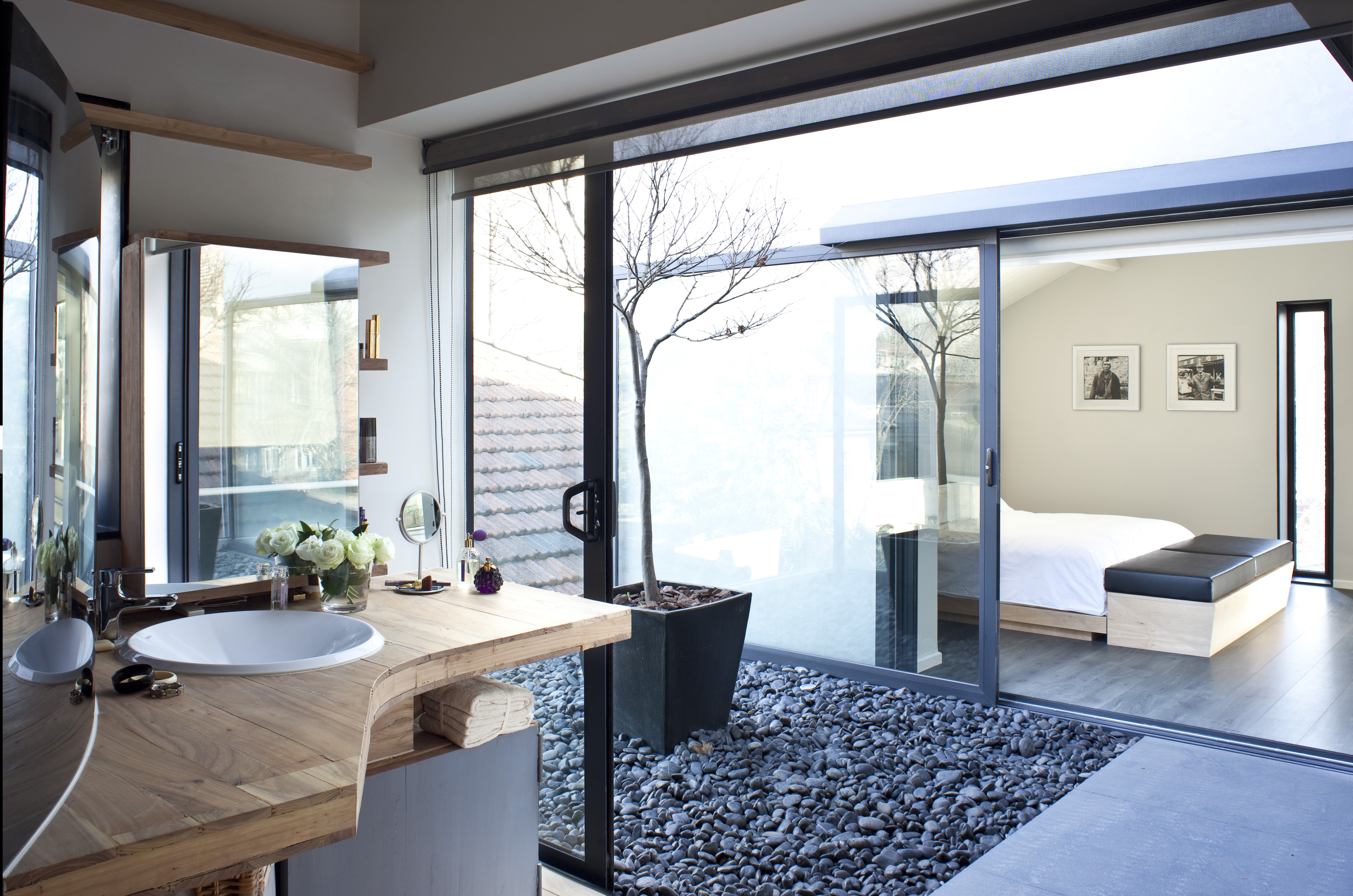 A small balcony floats between the master bedroom and bathroom