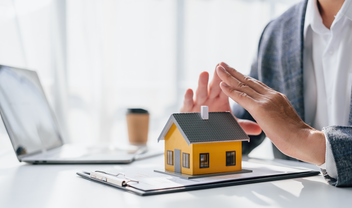 lawsuits against Real estate agent and realtor general liability insurance businessman professional discussing and consultant with house toy model building, protect your house and building