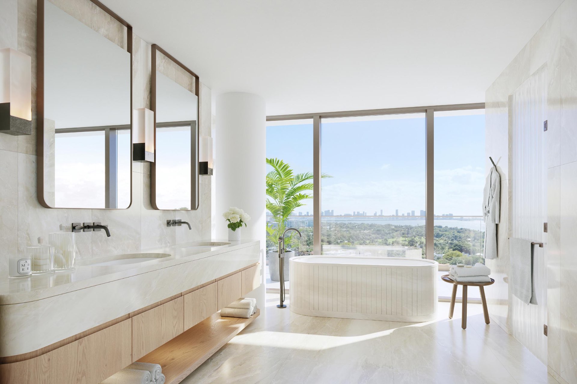 The Perigon primary bathroom with custom soaking tub and natural stone surround