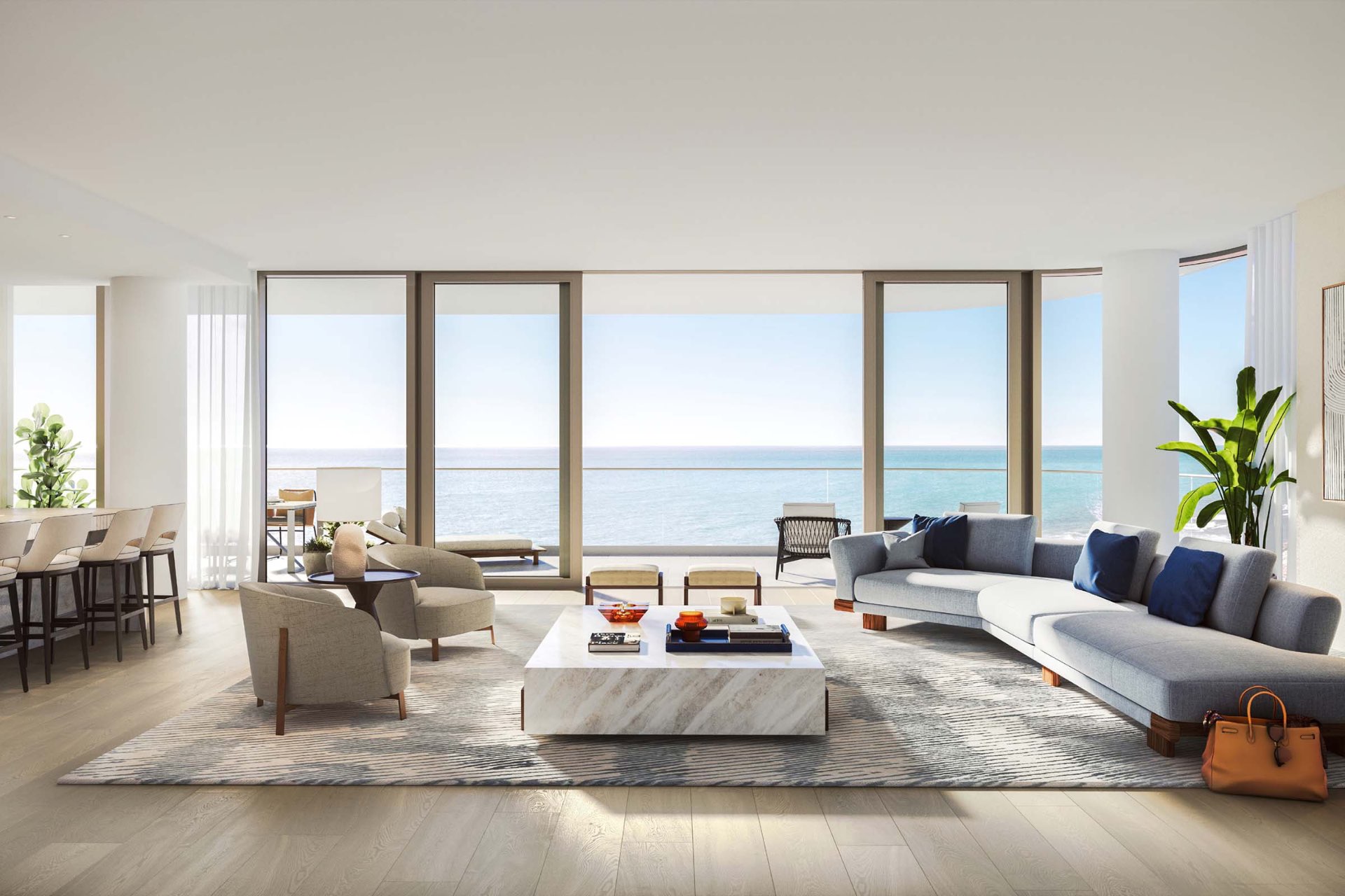 The Perigon residence living room with floor-to-ceiling windows and ocean views